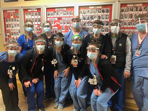 Group shot of medical workers wearing face shields donated by Milbank.