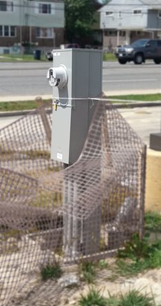 A Milbank U6221 pedestal being installed to provide power distribution to a nearby traffic signal.