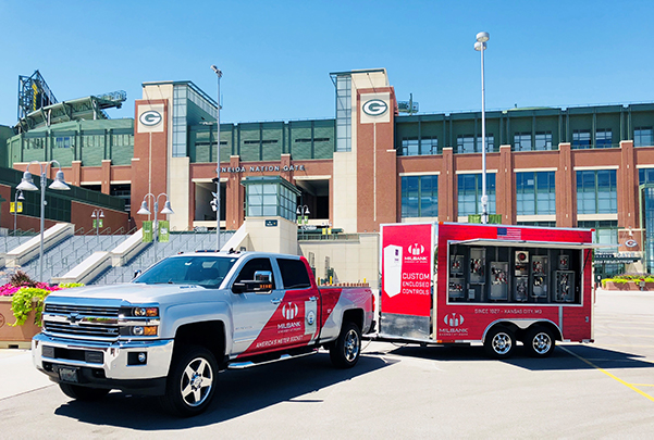 The Milbank truck and trailer parked in front of the Green Bay Packers football stadium.