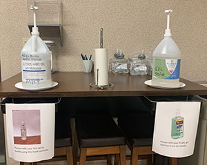 A hand sanitizer station where individual bottles from each workstation can be refilled.