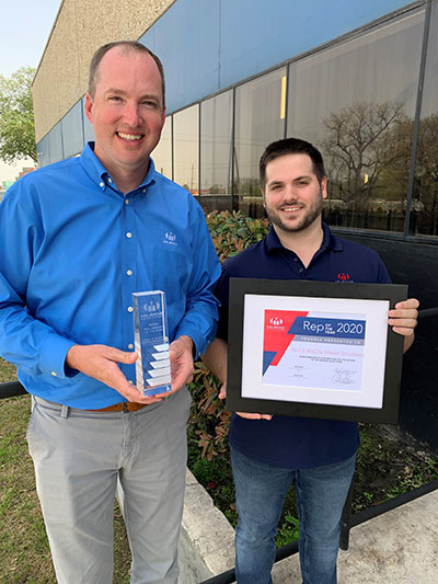 Two Bell & McCoy employees pose with their Rep of the Year award.