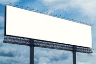 A blank white billboard on a background of blue sky.